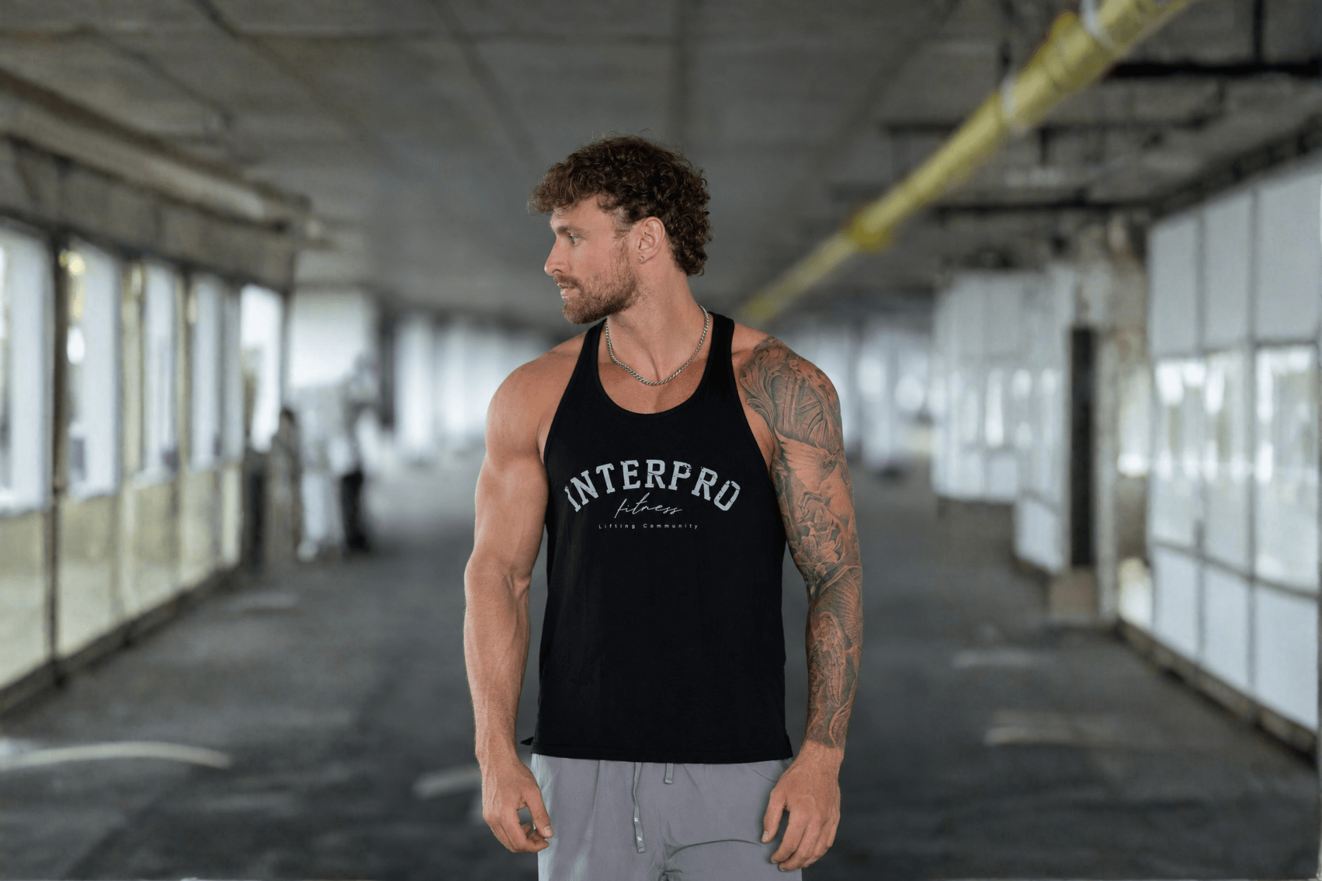 man wearing gym vest in urban setting 