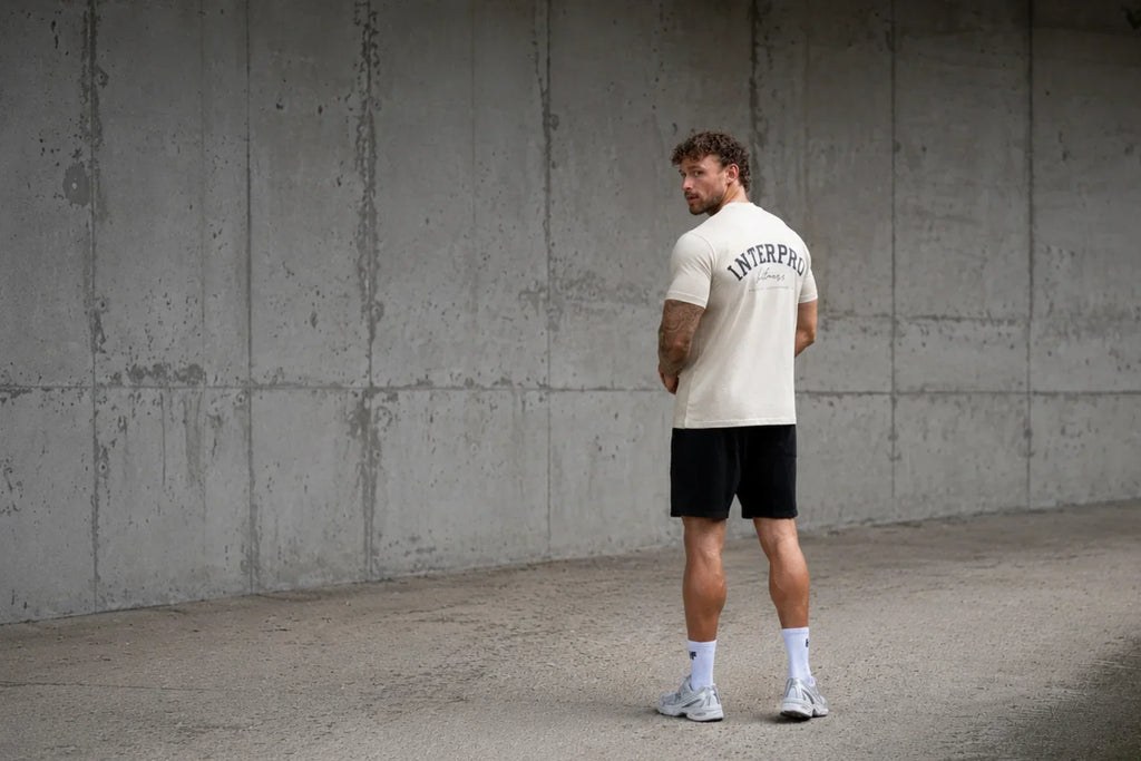 man wearing beige oversized gym t 