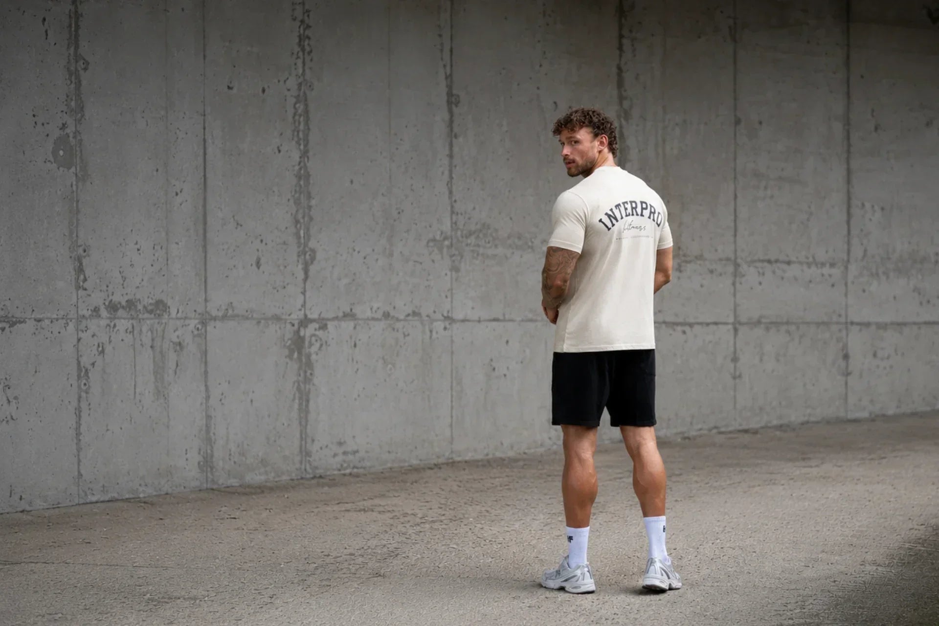 man wearing beige oversized gym t 