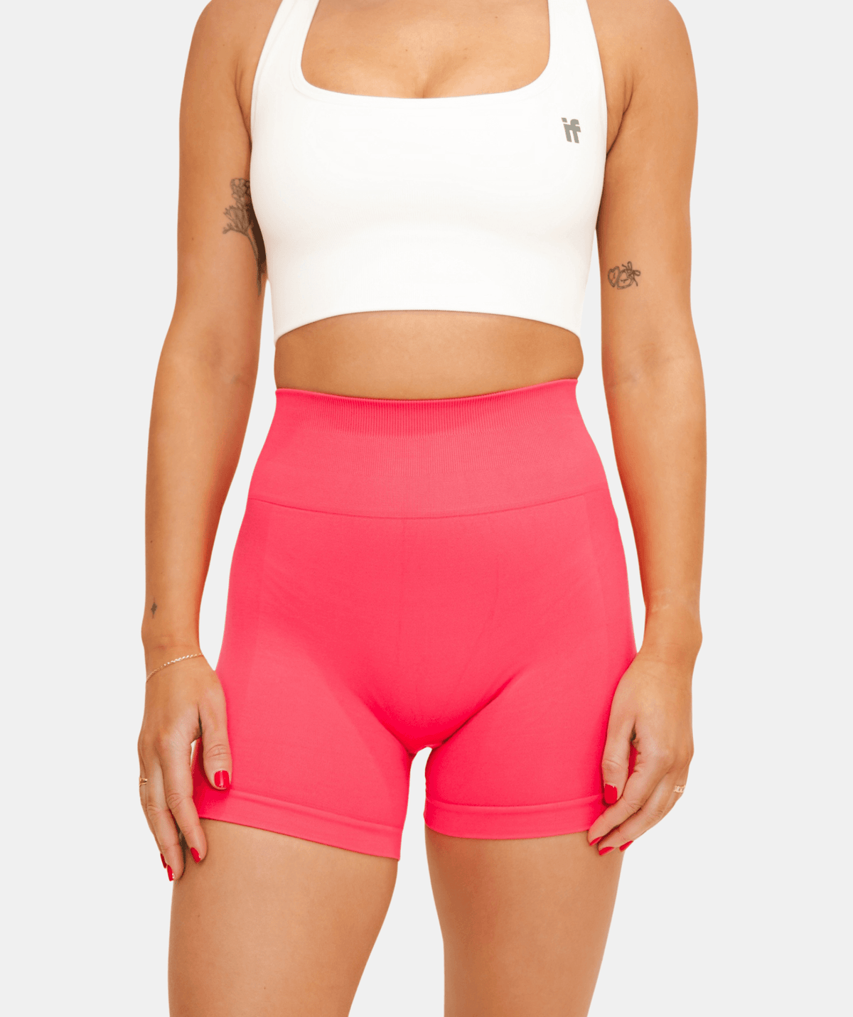 white sports bra and pink shorts 