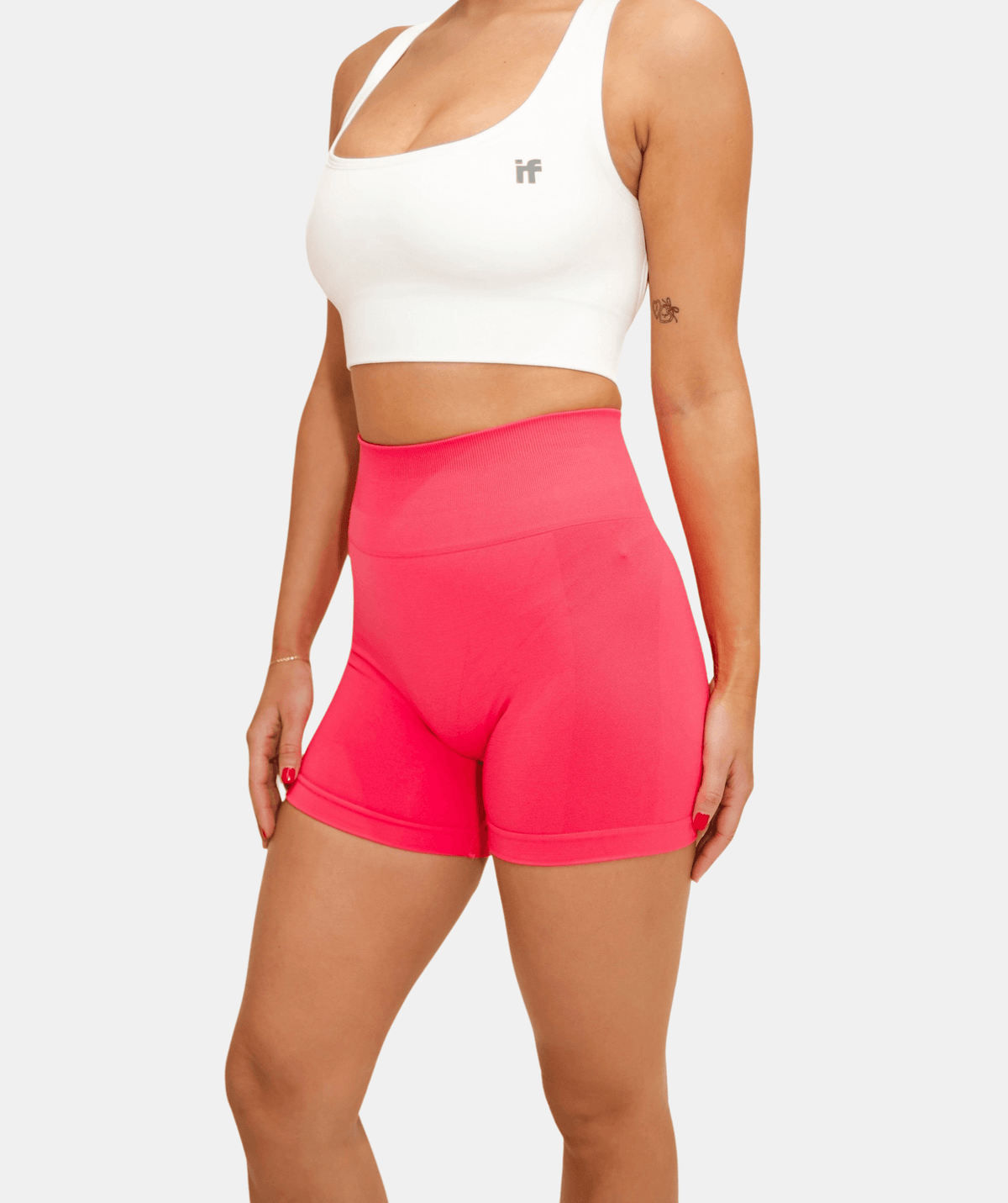 white sports bra and pink shorts 