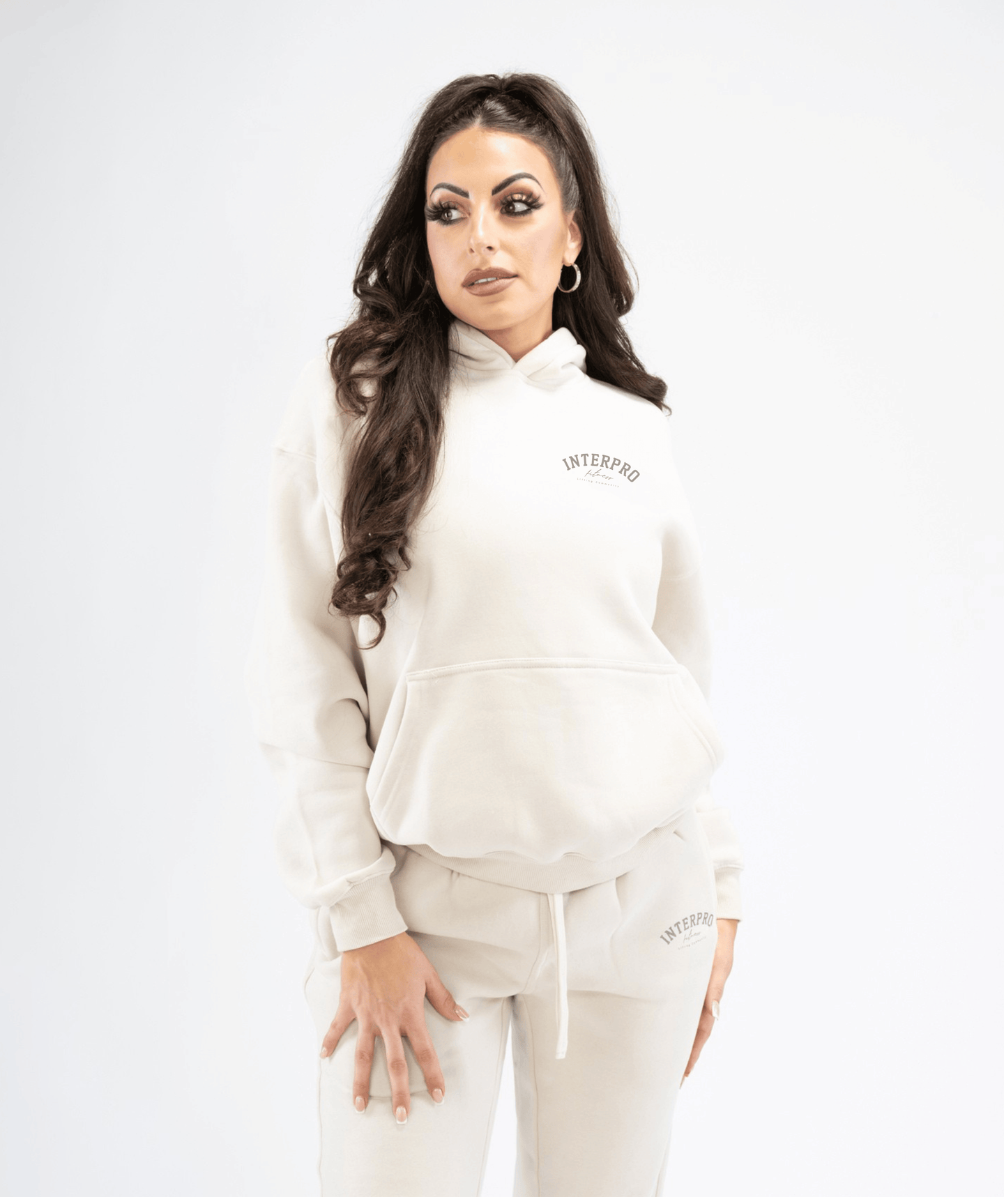 Front-facing view of women’s cream pullover hoodie featuring clean lines and a relaxed, comfortable fit