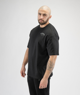 Side-angle view of Interpro Fitness Men’s Black Oversized Gym Tee with relaxed shape