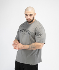 Men’s grey oversized training top side profile, highlighting relaxed silhouette.