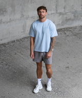 Men wearing Interpro light blue oversized gym t-shirt with training shorts