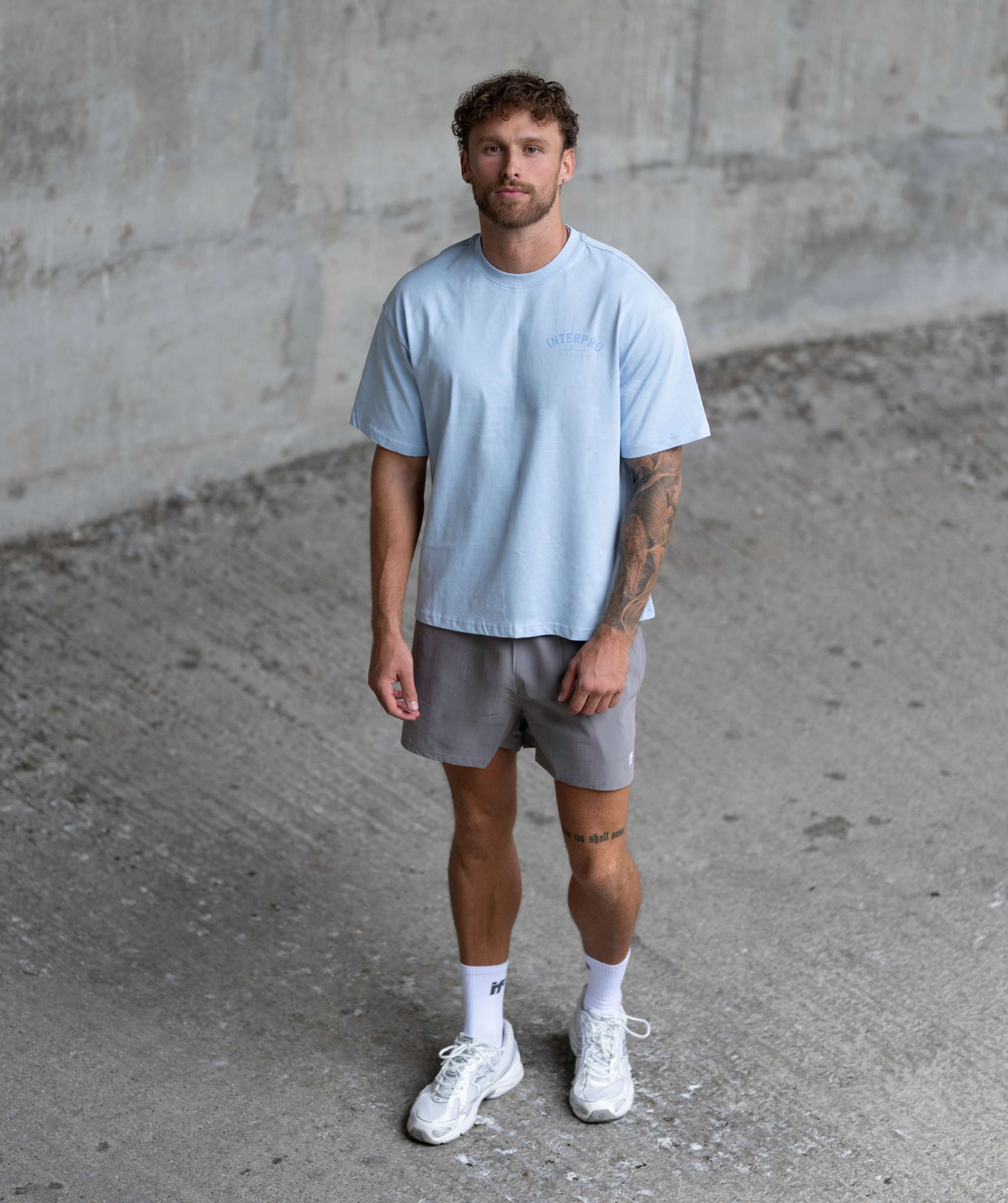 Men wearing Interpro light blue oversized gym t-shirt with training shorts