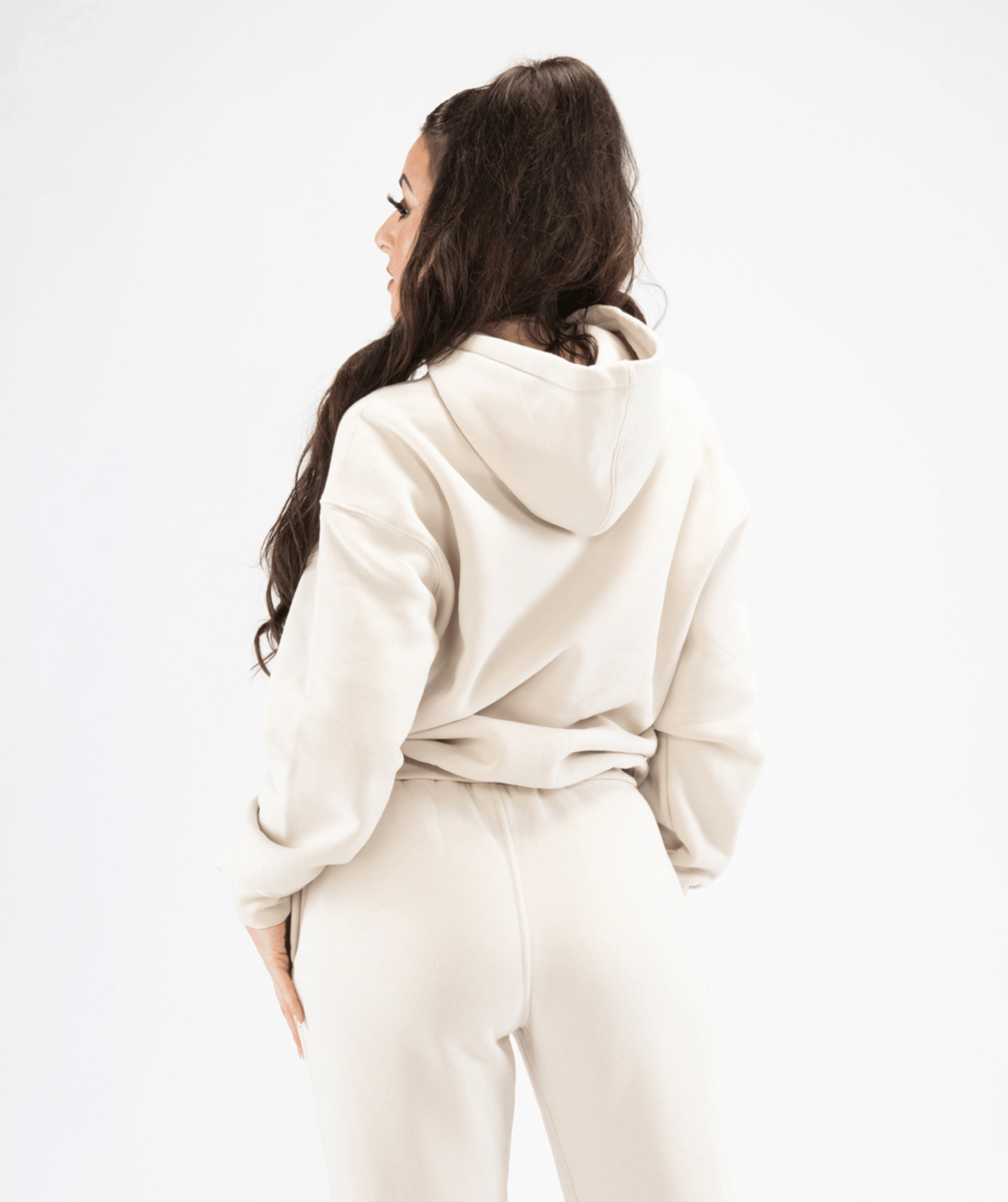 Rear view of cream pullover hoodie showing hood shape and smooth seam detailing