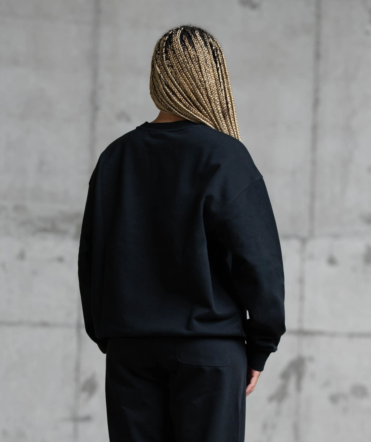 Person wearing a black sweatshirt and pants 