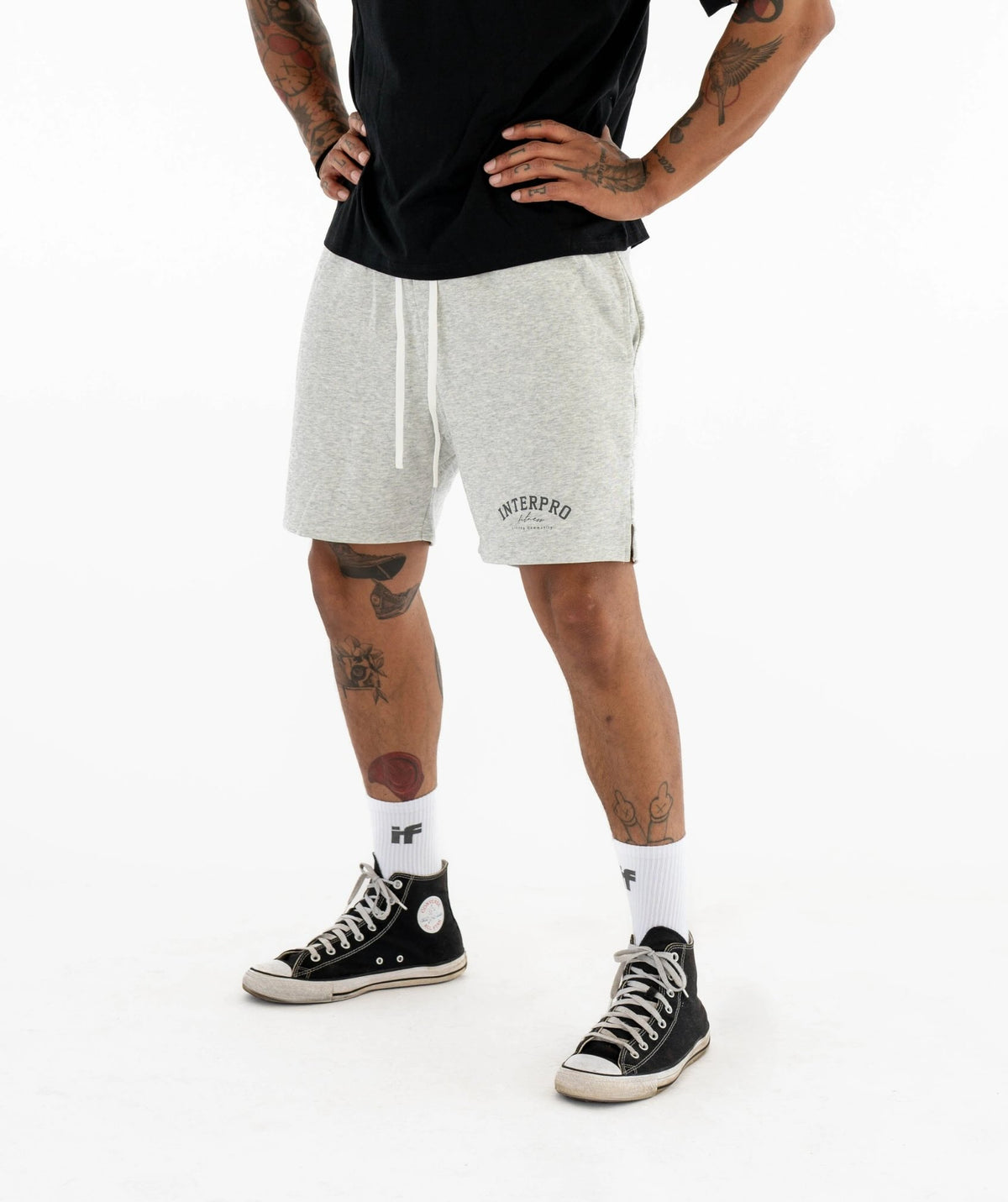 Person wearing gray shorts