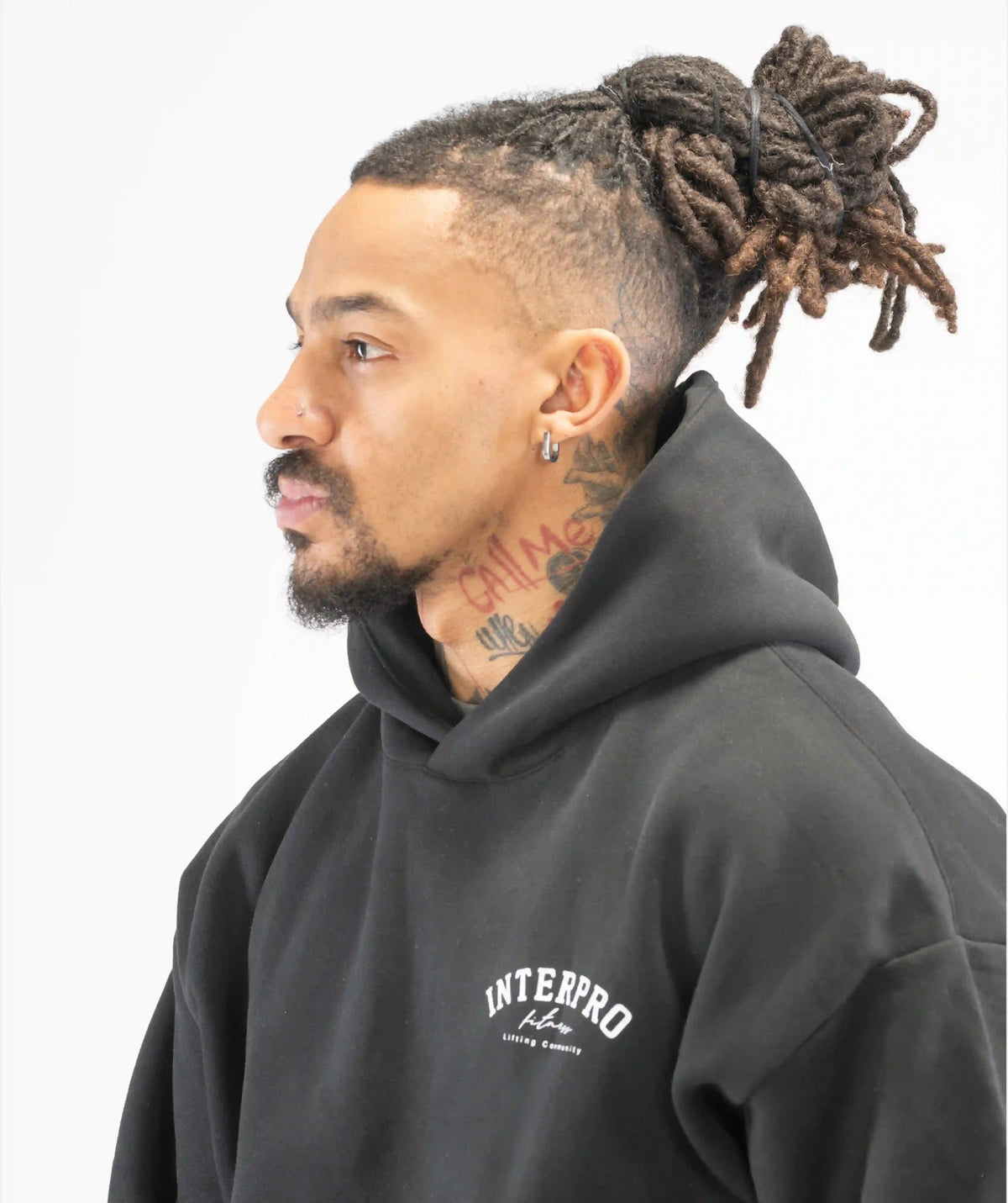 Man wearing a black hoodie with 'INTERPRO'