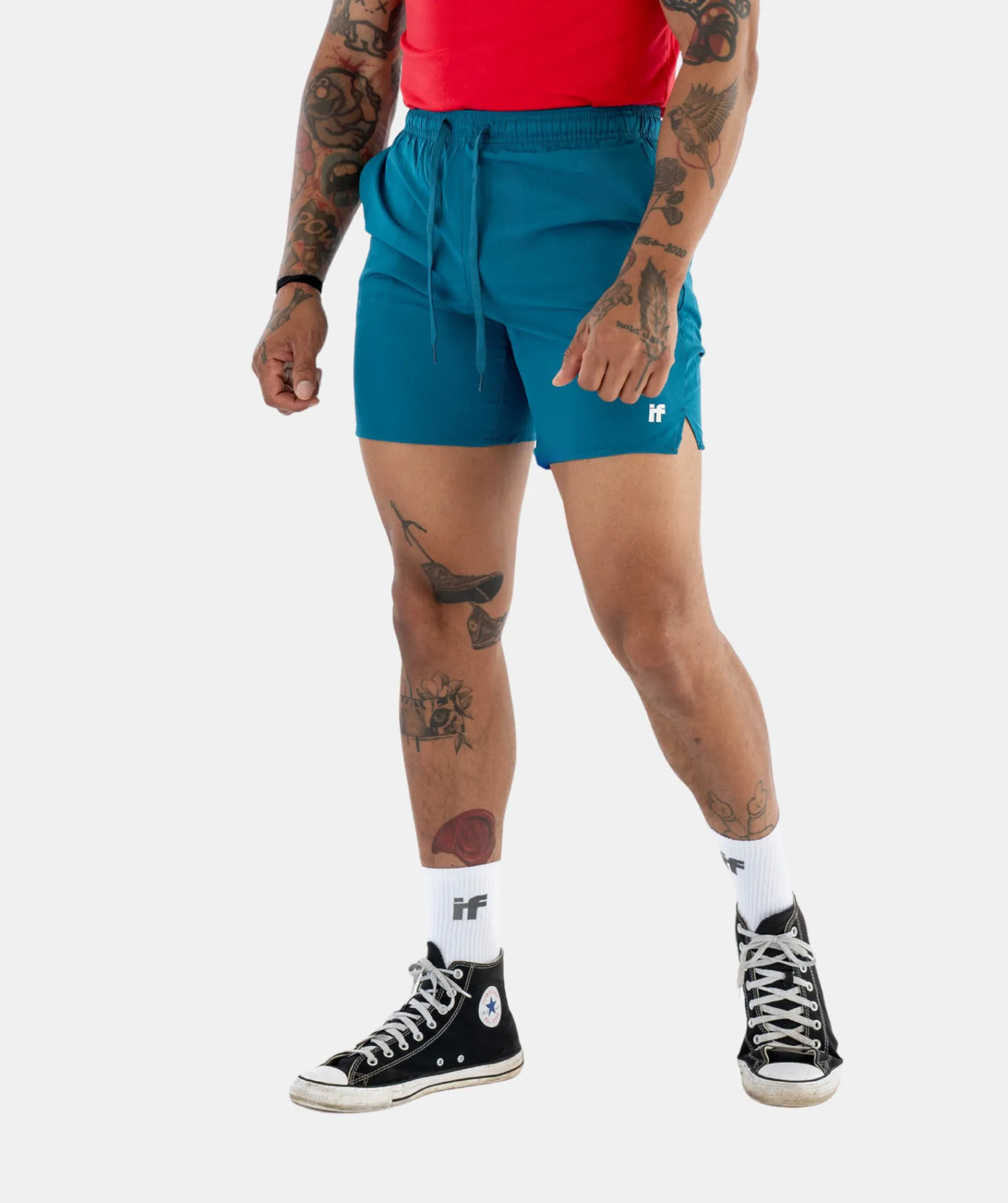 teal shorts, red top, black high-top sneakers, 