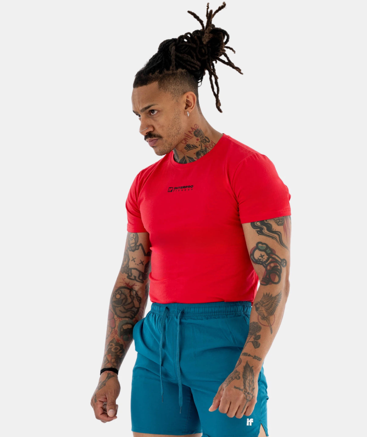 Man wearing red shirt & blue shorts 