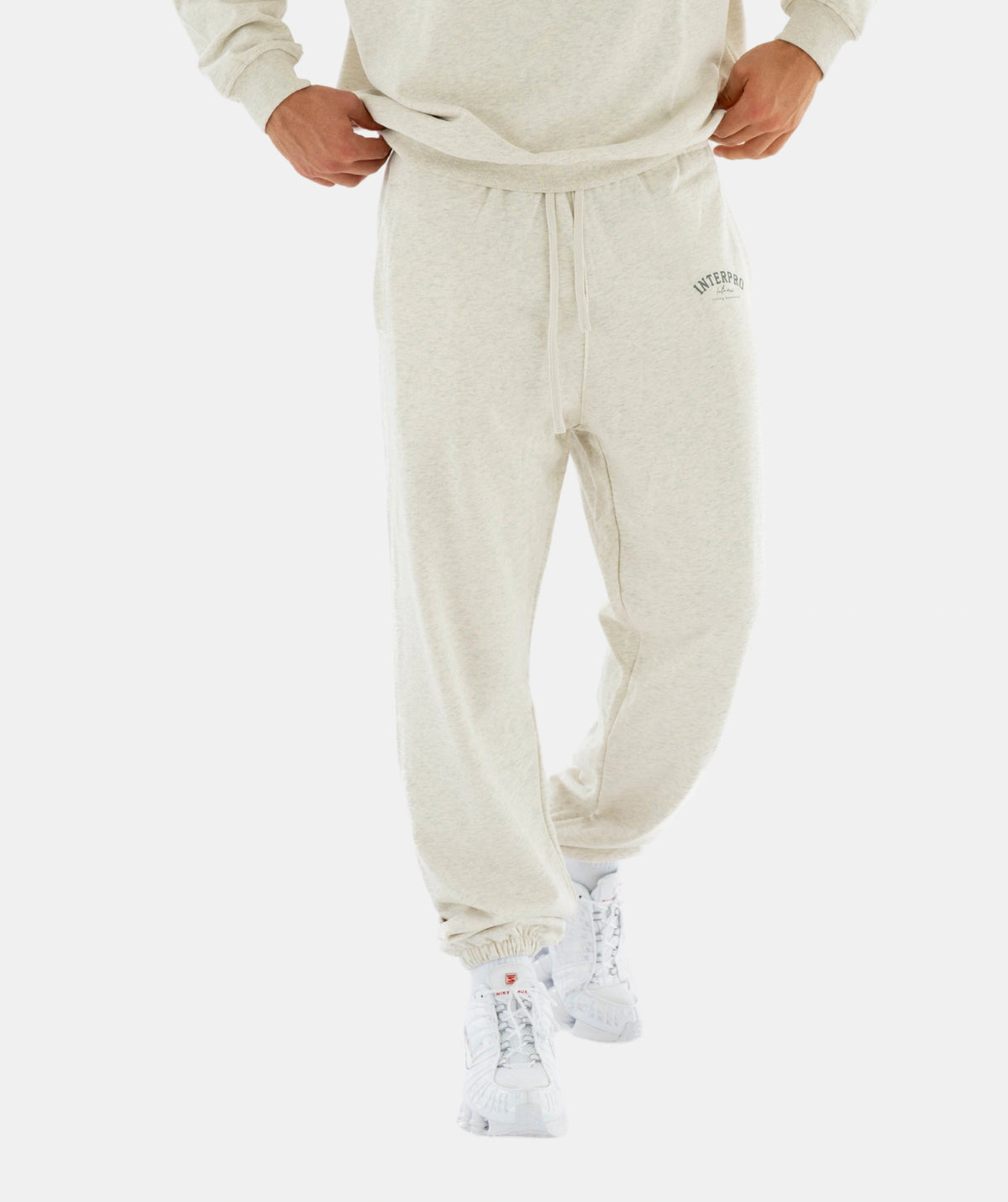 Person wearing a beige tracksuit 