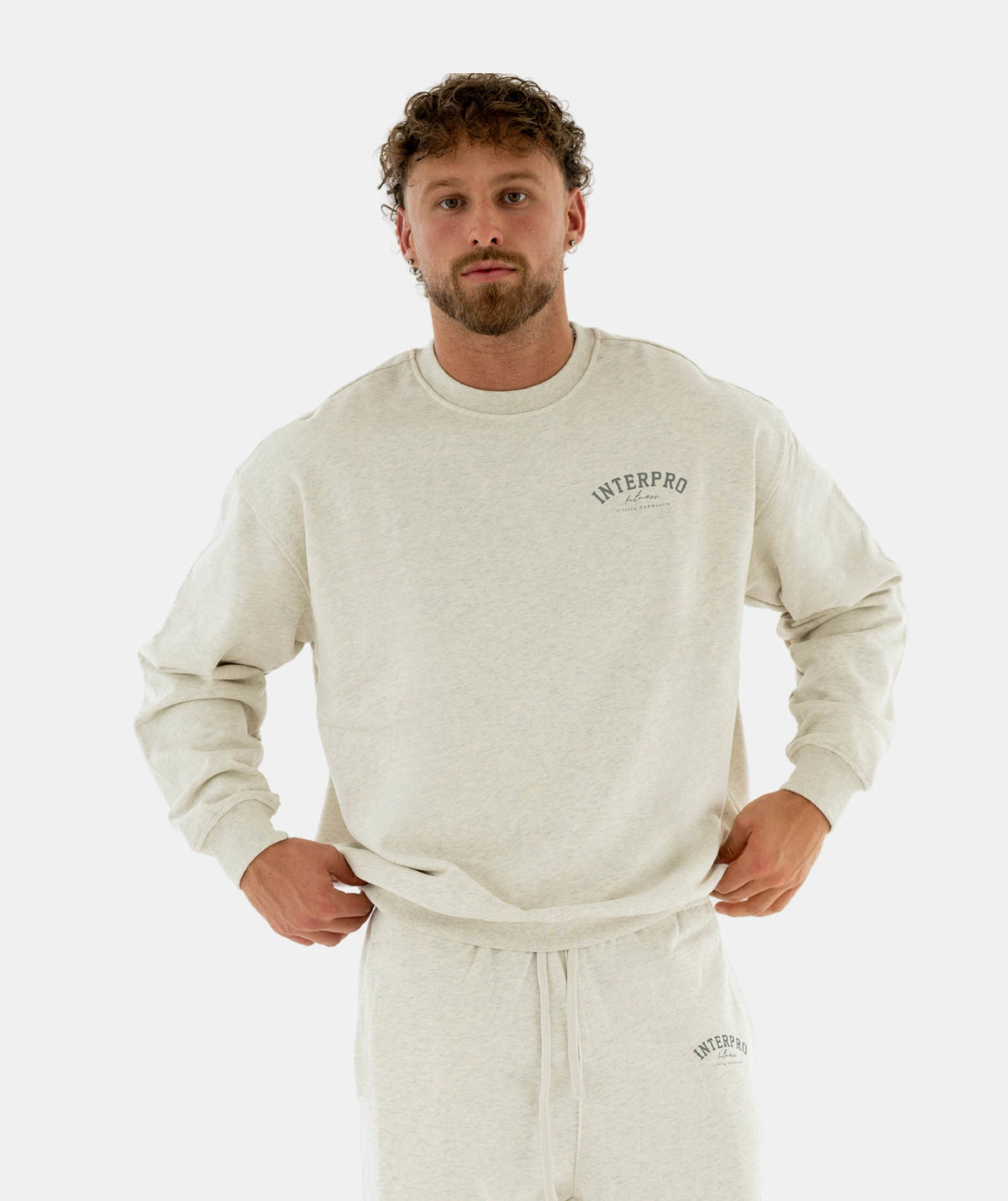 Man wearing beige sweatshirt & pants