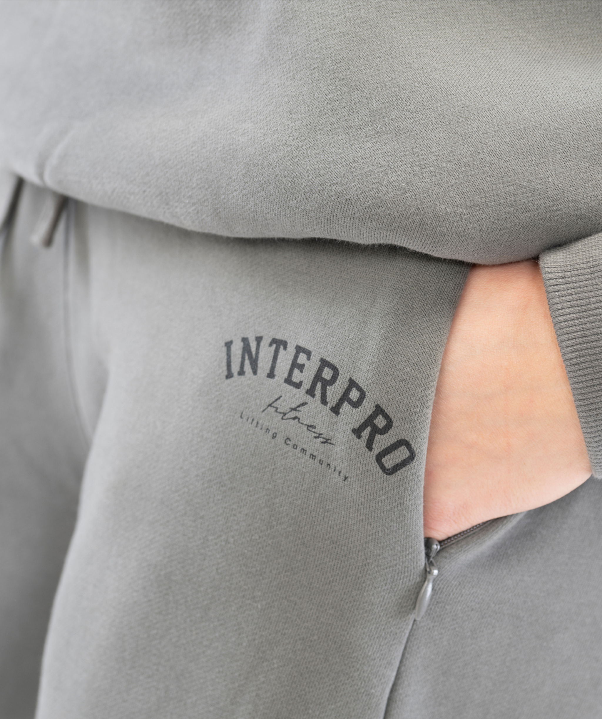 Detail shot of grey womens straight leg joggers fabric texture and Interpro Fitness logo