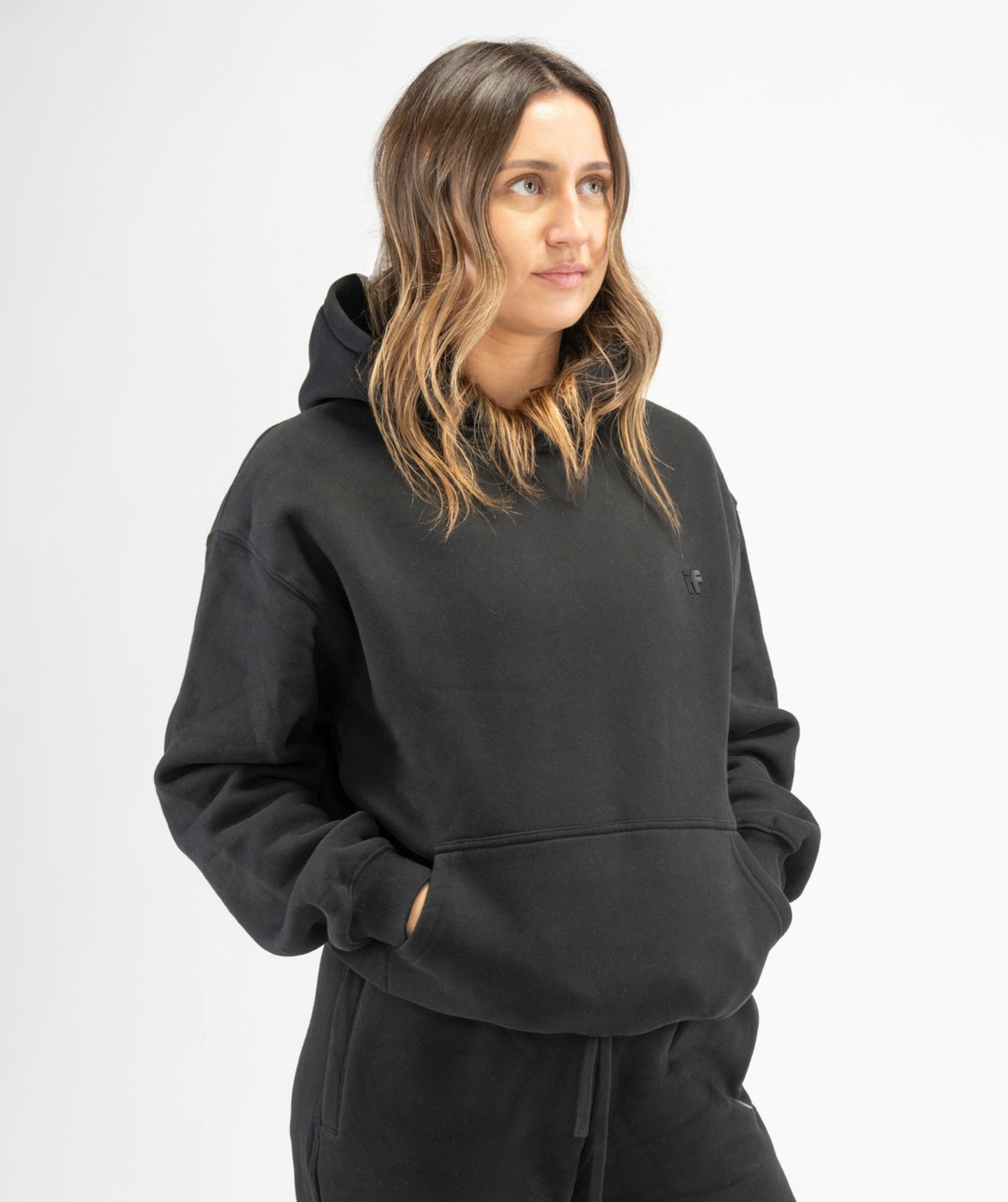 Front-facing shot of black women’s workout hoodie highlighting soft fabric and casual athletic silhouette