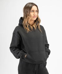 Front-facing shot of black women’s workout hoodie highlighting soft fabric and casual athletic silhouette