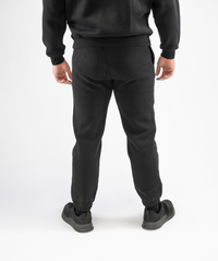 Back view of Interpro Fitness Men’s Regular Fit Gym Joggers in Black highlighting cuffed ankles and clean rear design.