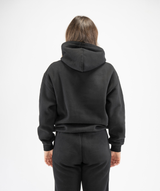 Rear view of women’s black pullover gym hoodie showing hood structure and clean back panel
