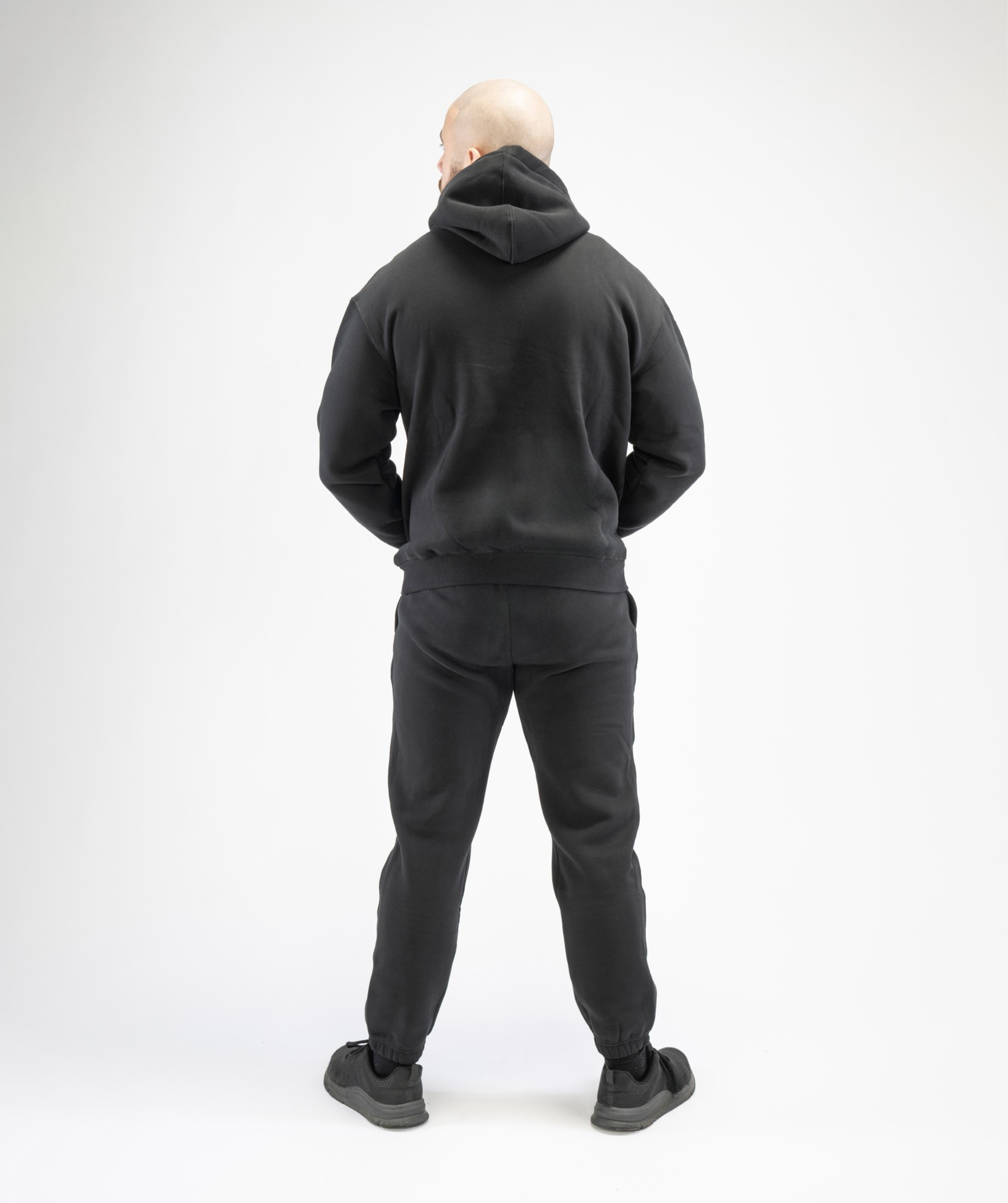 Full-body rear outfit image featuring Interpro Fitness Men’s Black Regular Fit Joggers combined with gym wear.