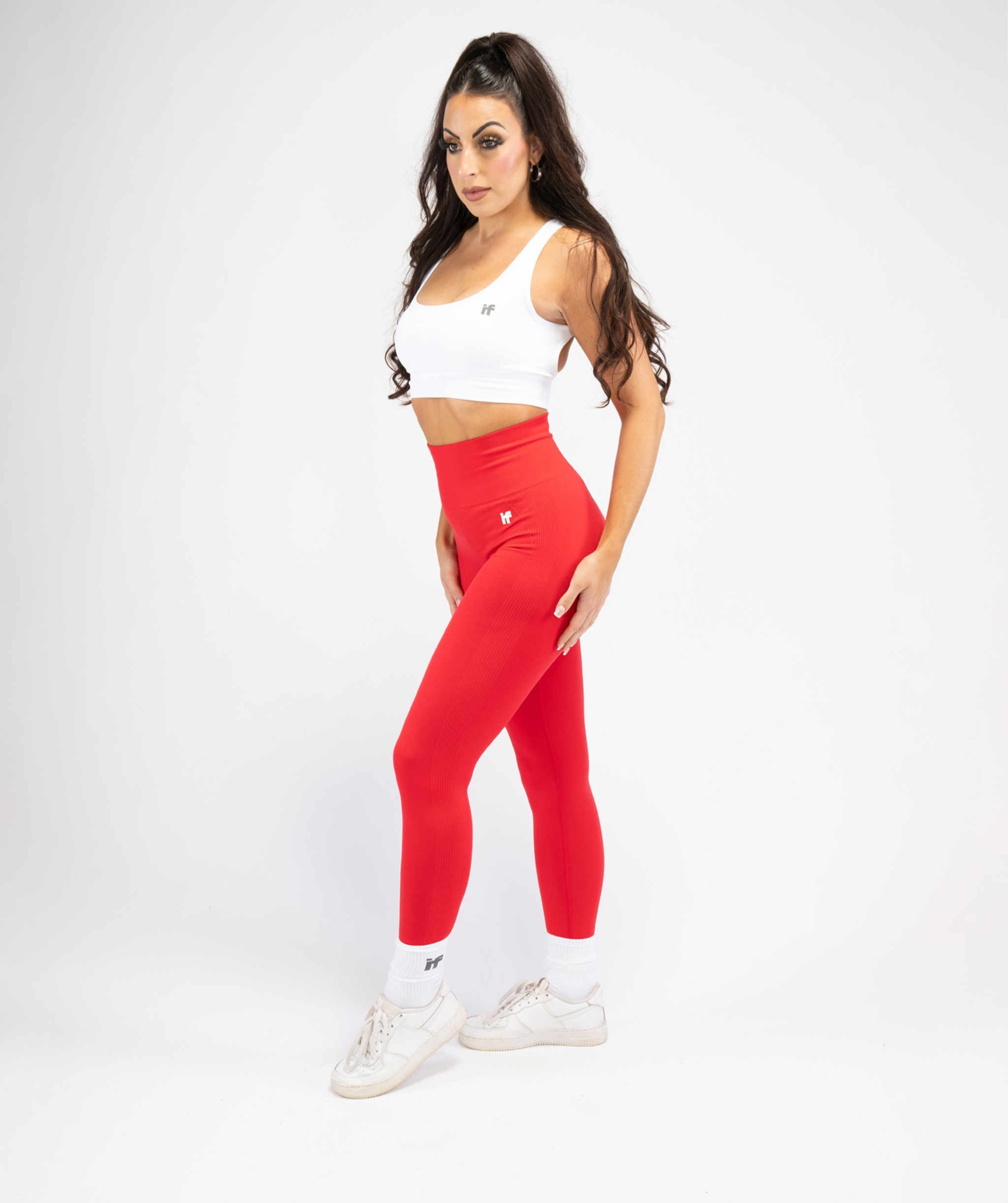 Full-body outfit featuring Interpro Fitness red sculpt leggings from side view with pose.