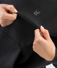 Close-up of Interpro Fitness logo on black women’s hoodie showing silicone detailing