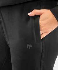 Detail shot of Interpro Fitness black womens joggers fabric texture and silicone logo