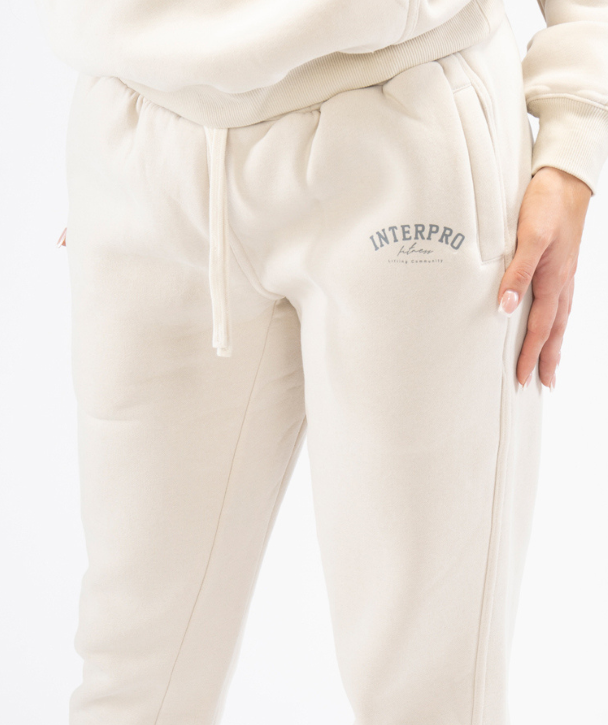 Close-up of cream Interpro Fitness joggers pocket and logo