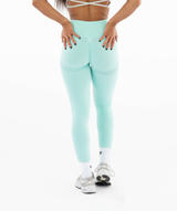 Interpro fitness womens model wearing light green leggings on a white background