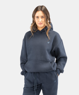 Front view of women’s Interpro Fitness navy blue hoodie showing relaxed fit and minimalist design