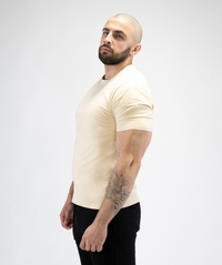 Side view of Interpro Fitness Men’s Beige Gym Tee, showcasing fitted sleeve and tapered shape