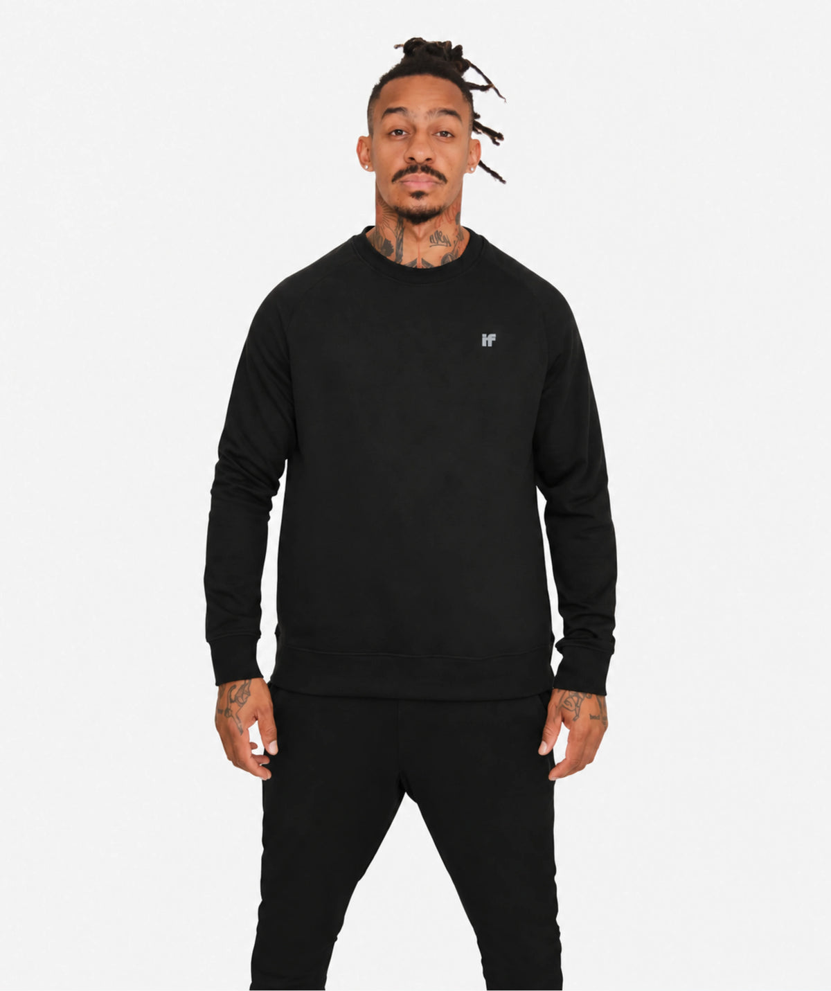 Man in black gym sweater front facing on white studio background