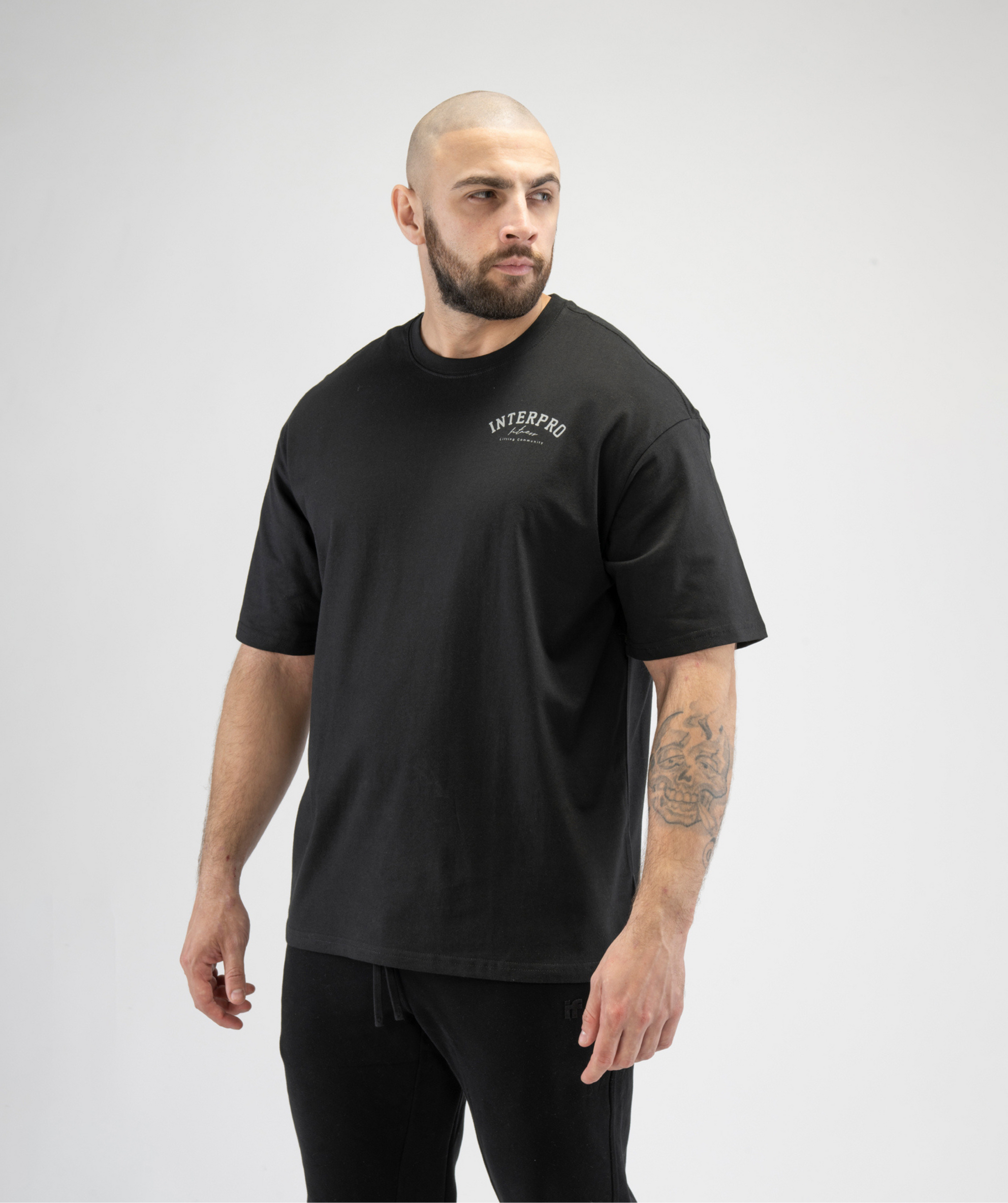 Black oversized men's gym T-shirt by Interpro Fitness, showcasing loose performance fit.