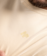 Colour-matched IF logo close-up on beige training tee for men