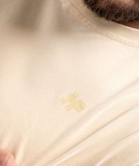 Colour-matched IF logo close-up on beige training tee for men
