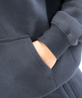 Close-up of kangaroo pocket stitching on women’s navy blue hoodie highlighting clean seam work