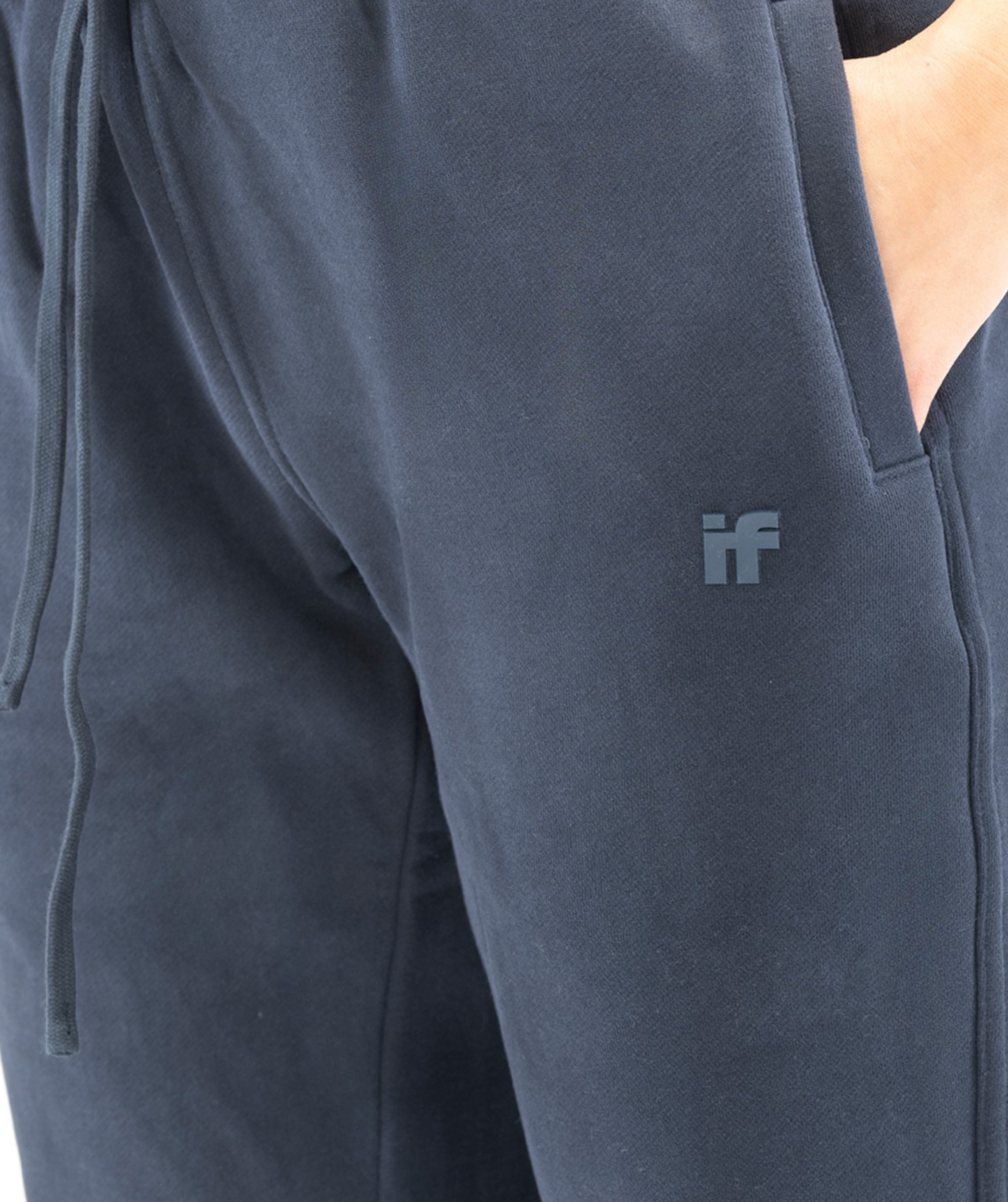 Side pocket close-up on navy Interpro Fitness joggers showing logo