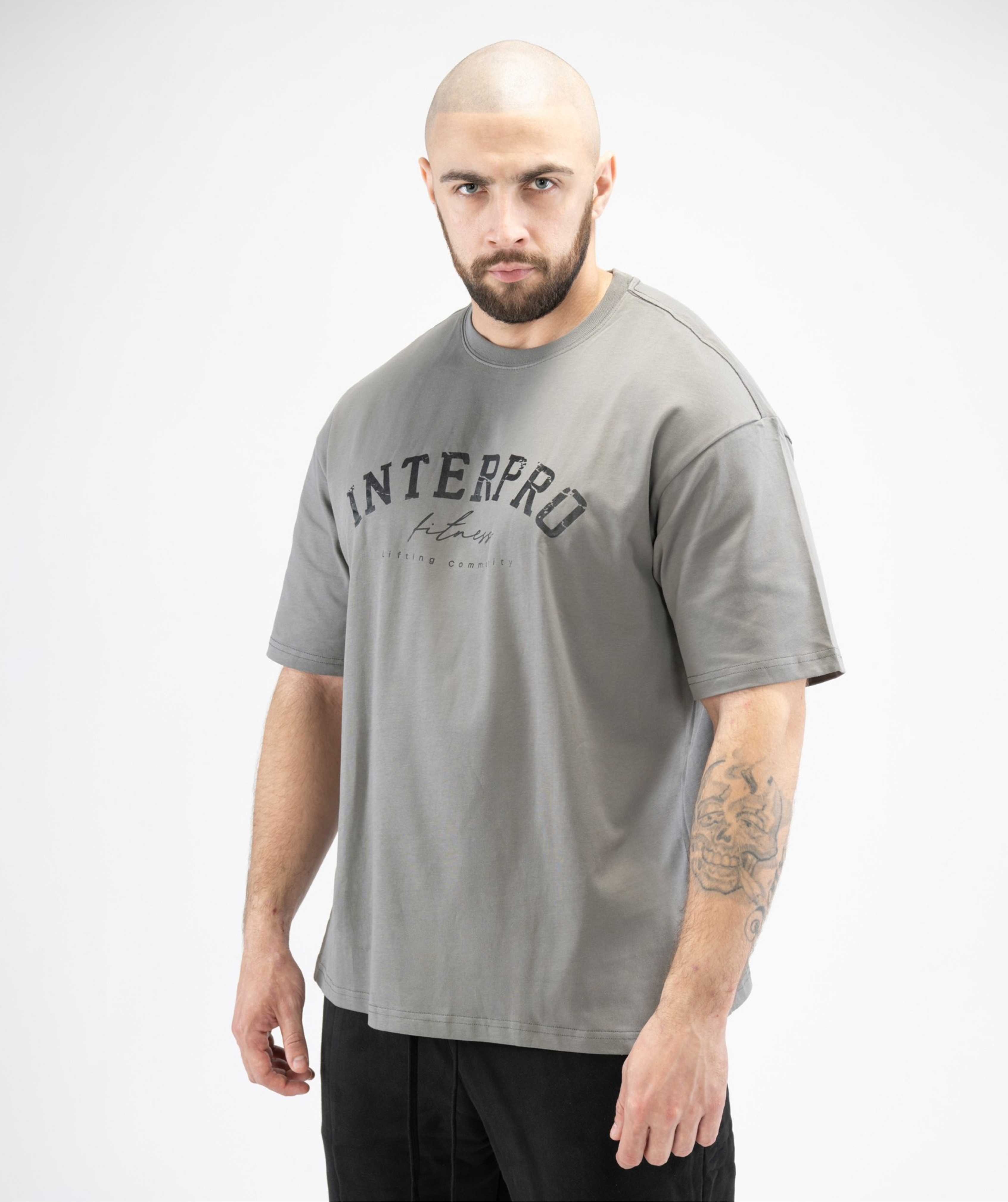 Grey oversized men’s gym tee, side angle showing large front Interpro logo