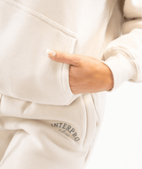 Close-up of womens pullover hoodie displaying high quality fabric and stitching detail on pockets 