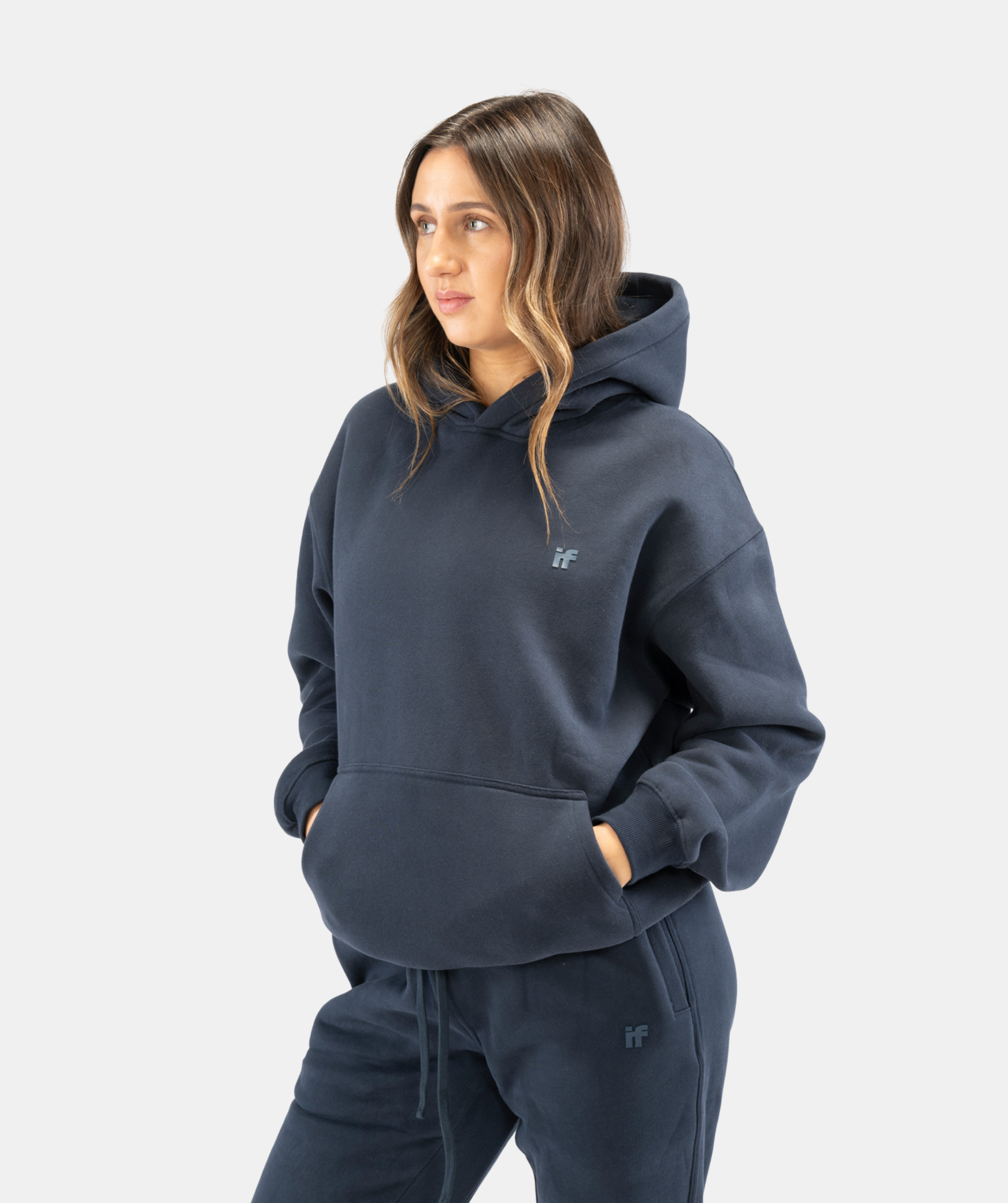 Side angle of women’s navy blue pullover hoodie highlighting soft fabric and clean silhouette
