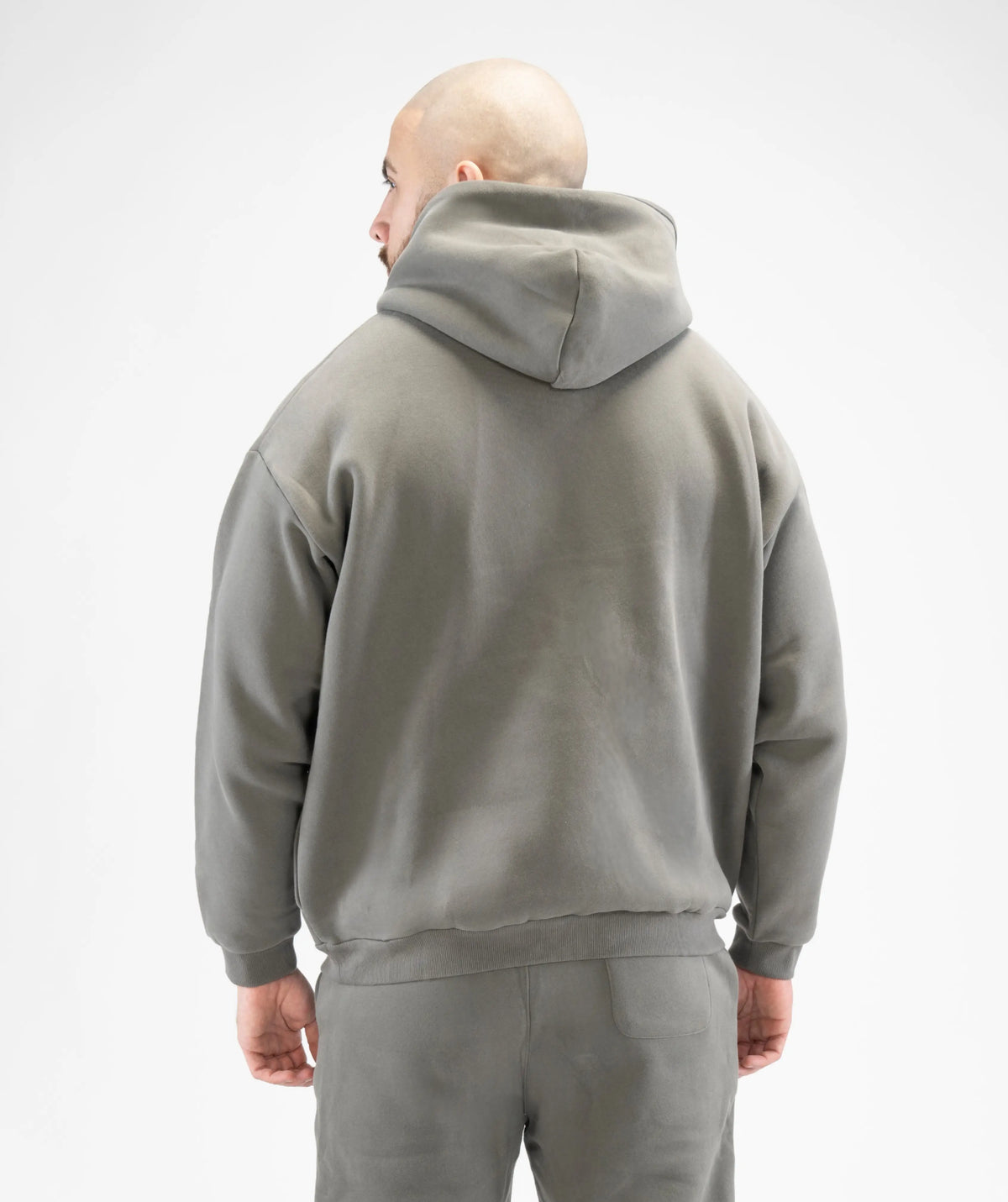 Person wearing a gray hoodie and pants