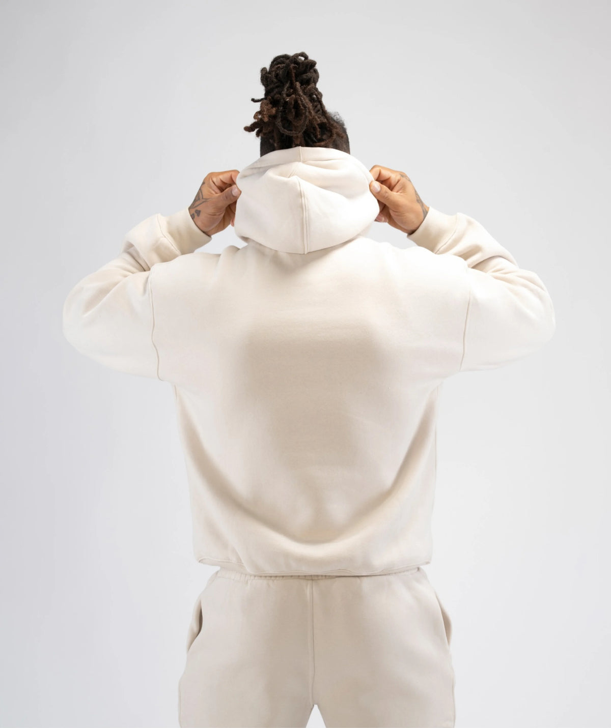 Person wearing a beige hoodie