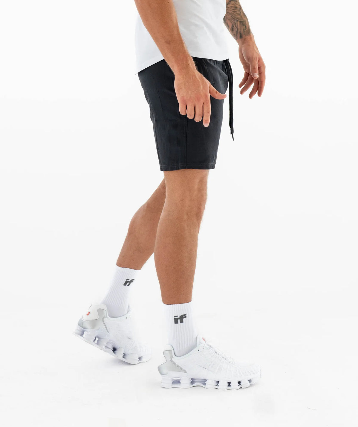 black athletic shorts and white sneakers