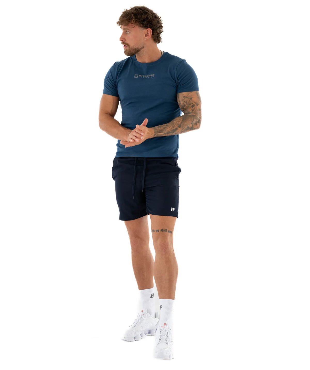 Man wearing a blue t-shirt and black shorts
