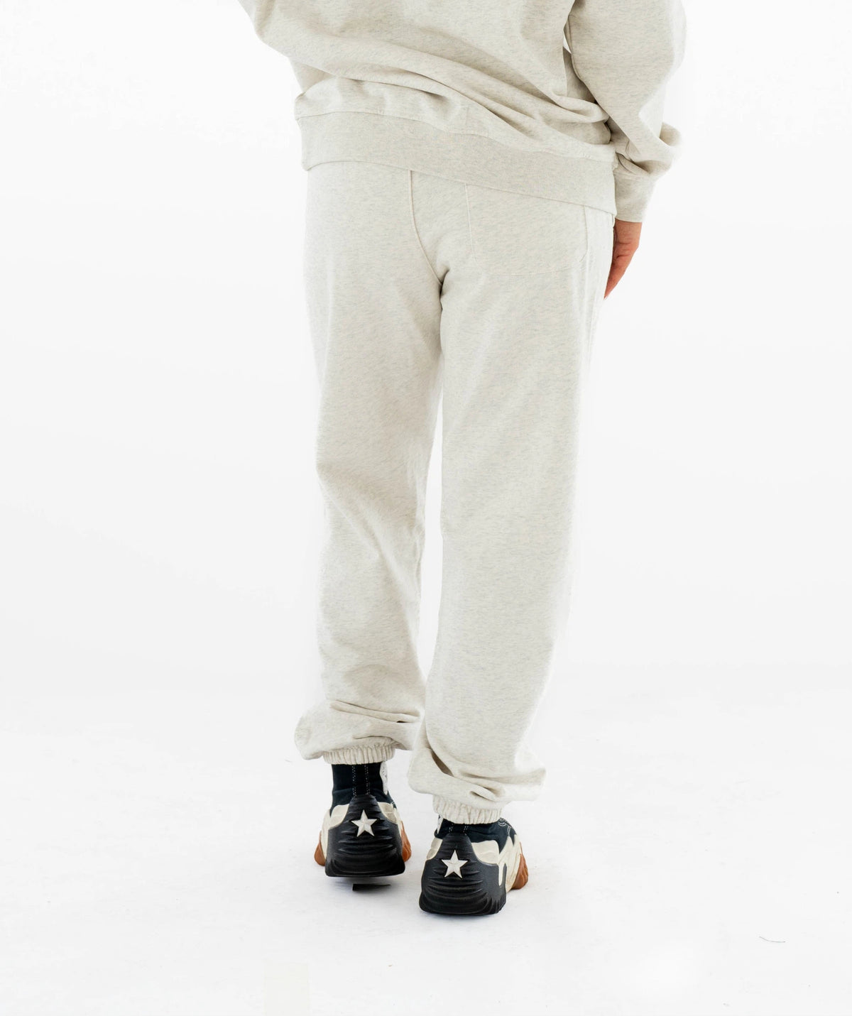 beige sweatpants and black shoes 