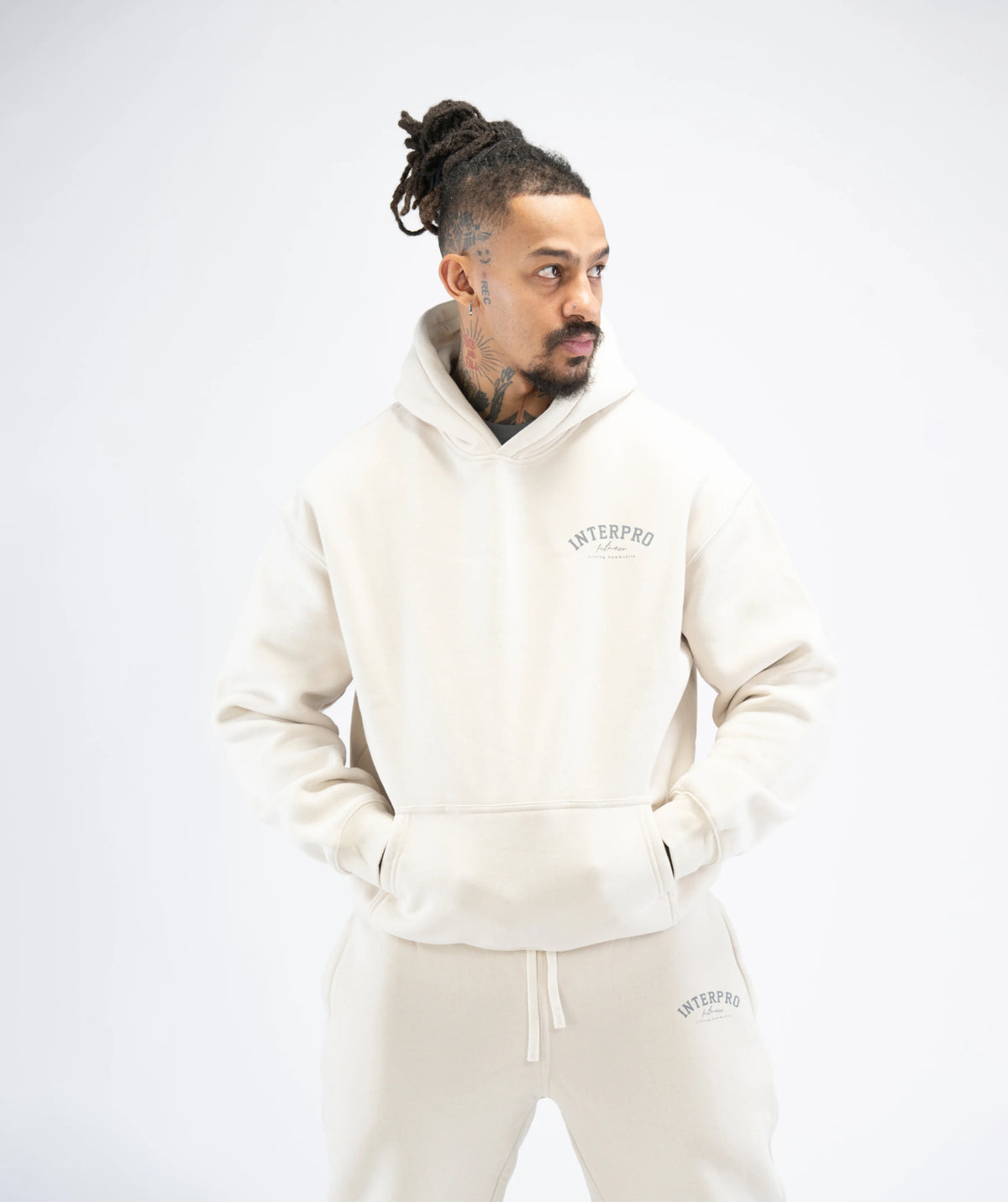  beige hoodie and pants with a brand logo 