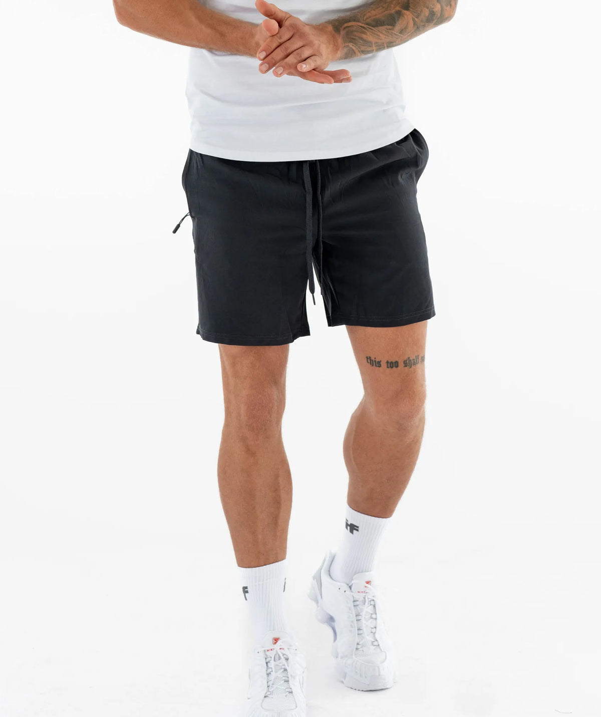  black shorts and white sneakers 