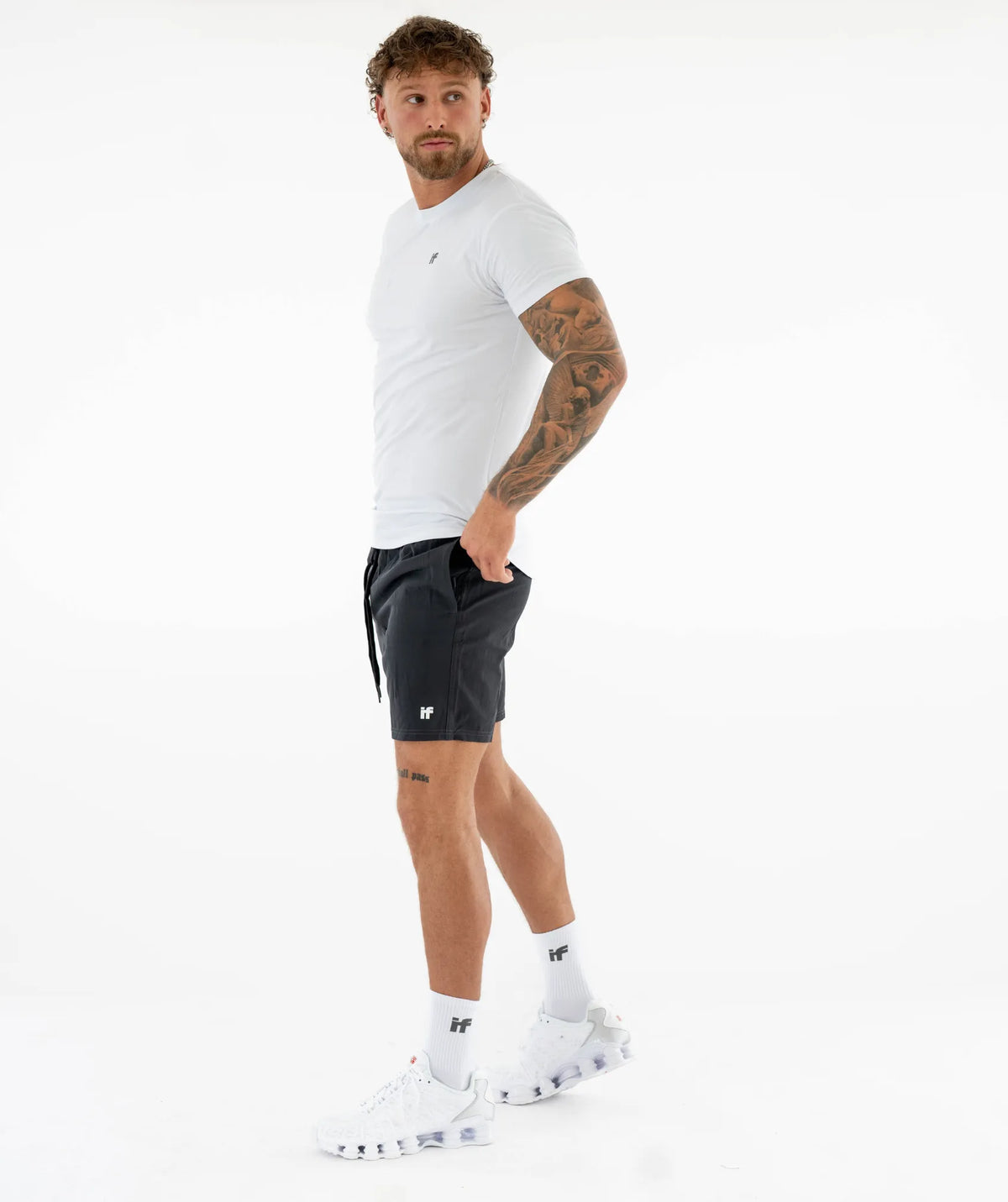 Man wearing a white t-shirt and black shorts
