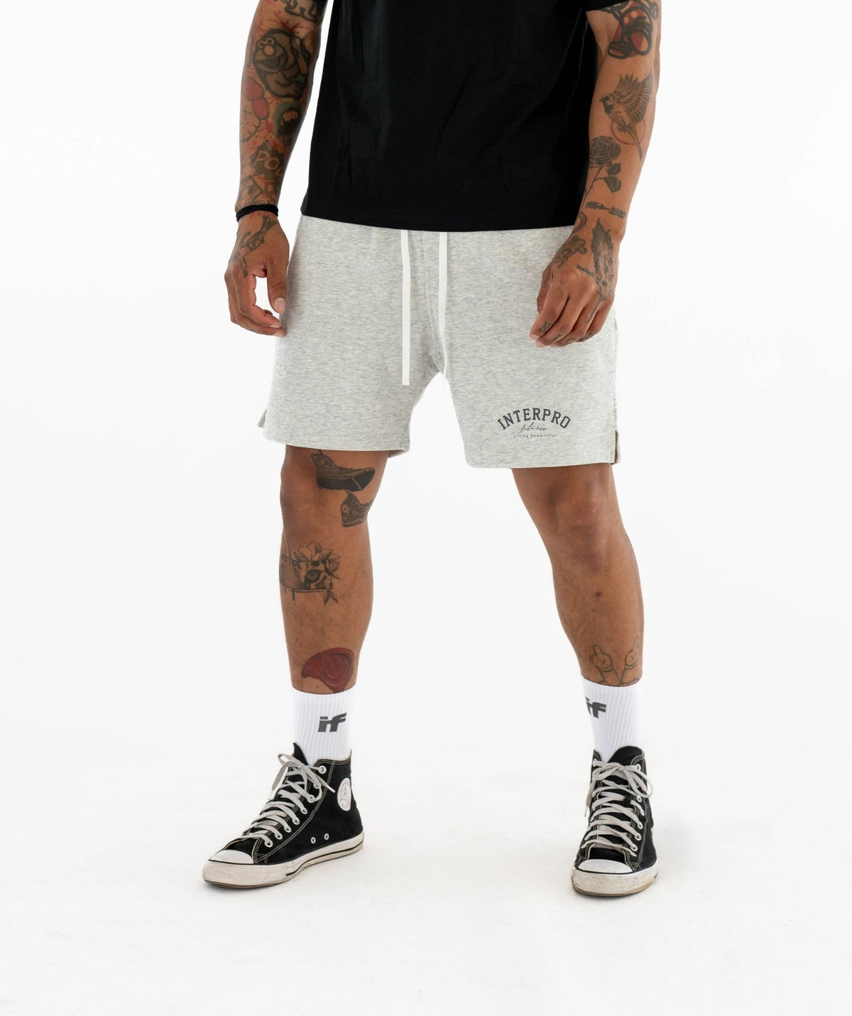 wearing gray shorts with brand logo 