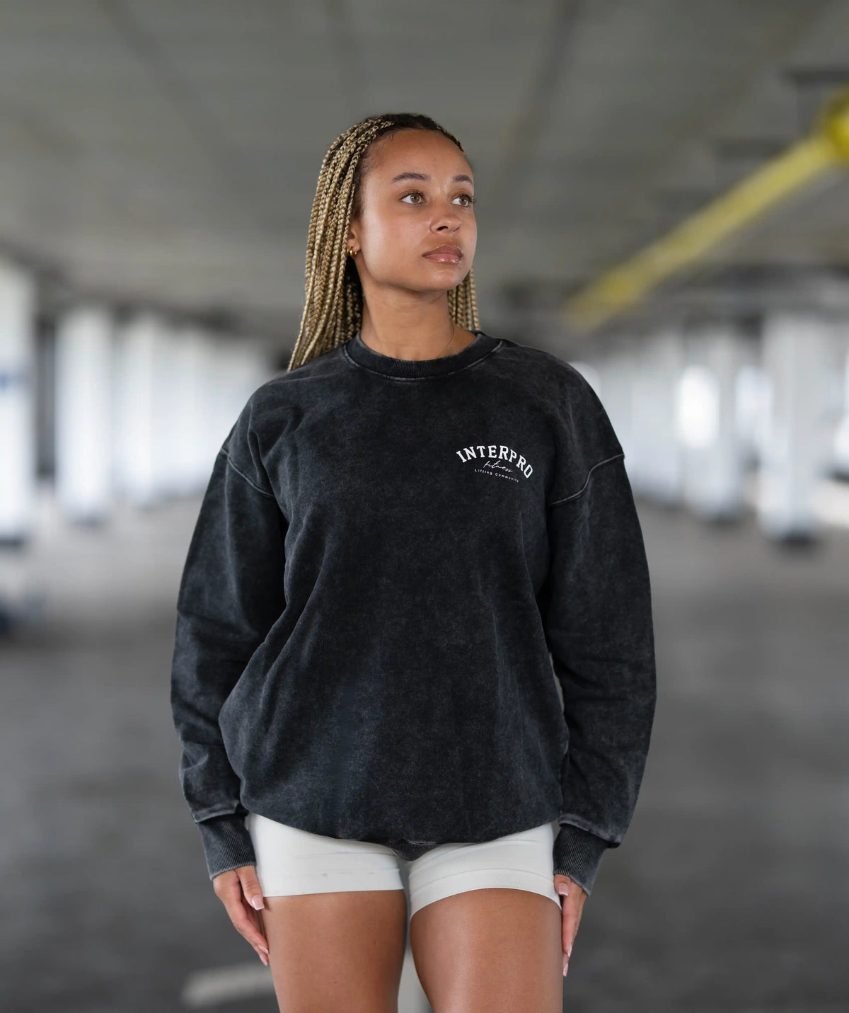  black sweatshirt with text in an indoor setting